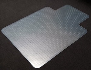 Clear 900x1200 PVC HD keyhole chair mat with reverse spikes on commercial carpet
