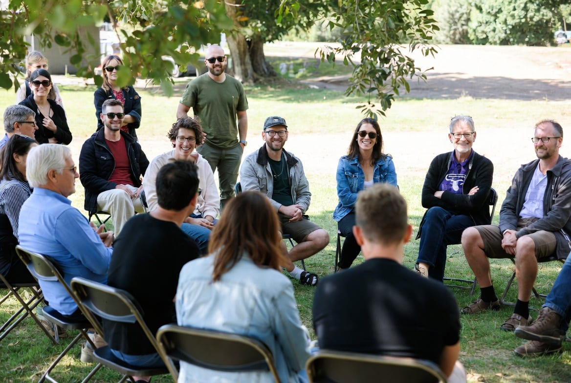 People seated on foldable chairs at an outdoor NZ event or gathering
