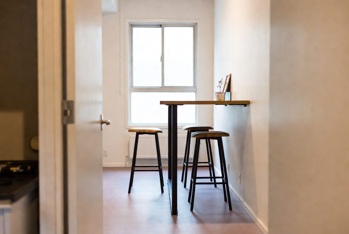 Compact bar leaner used as dining area in small NZ apartment or hospitality venue