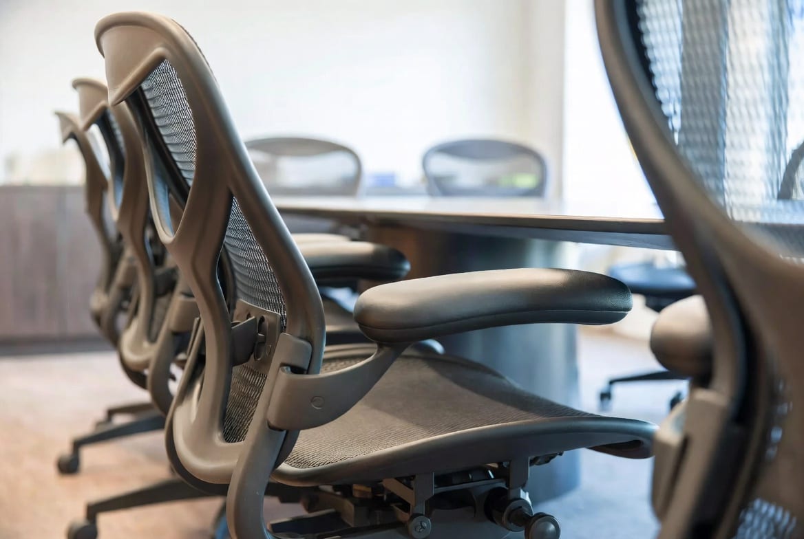 Comfortable ergonomic meeting boardroom chairs arranged around a sleek boardroom table in corporate NZ office