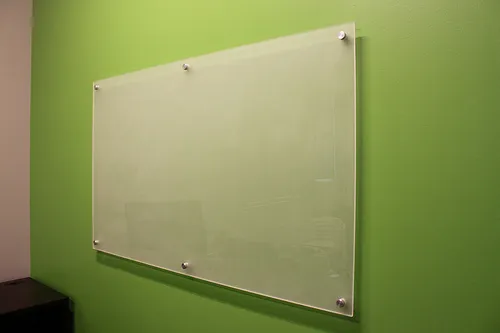 Modern glass whiteboard in professional NZ office meeting room