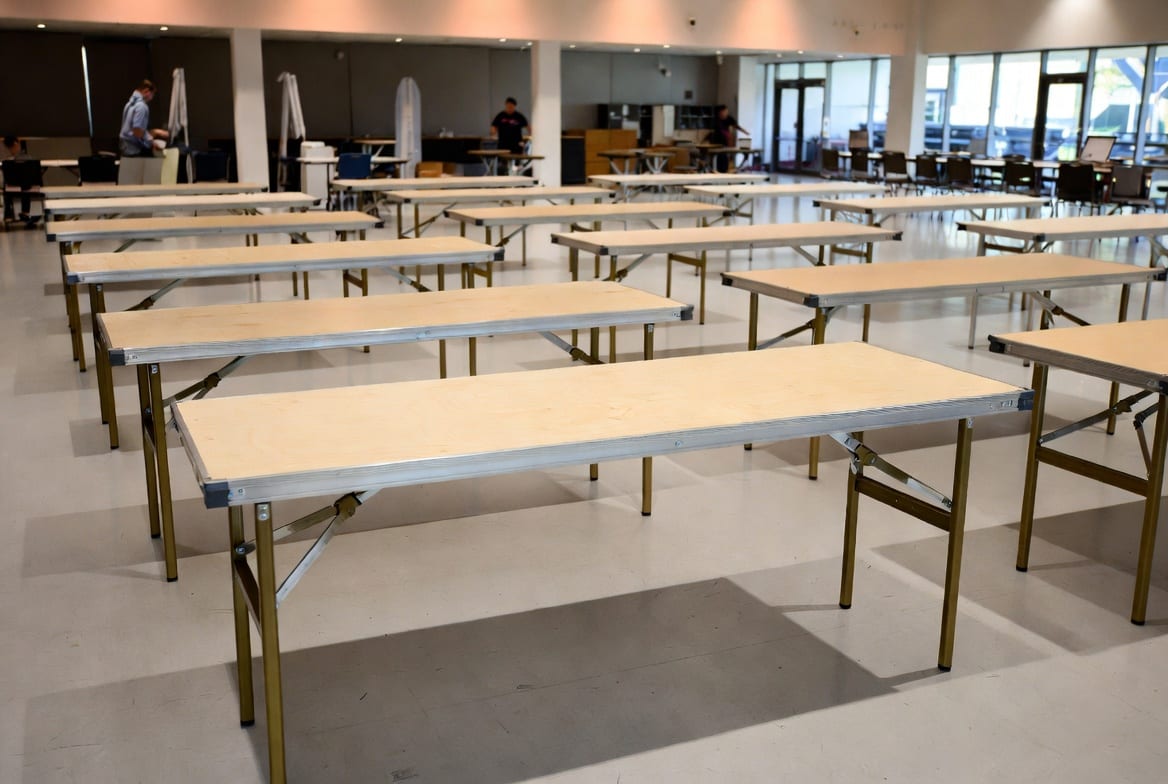 Heavy duty folding tables set up in a busy New Zealand commercial venue