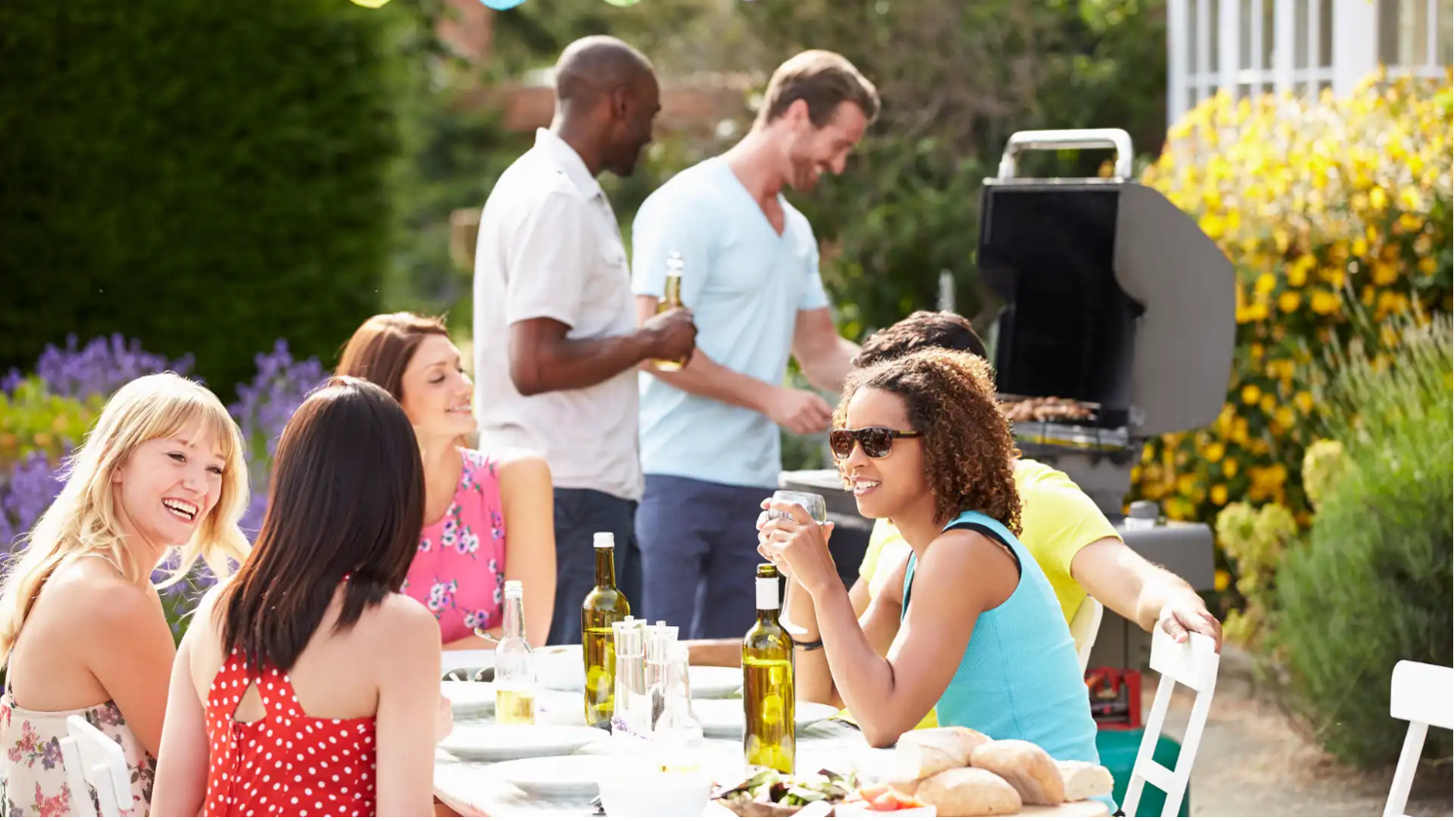 Group of friends at a barbecue, sitting at a lightweight folding table