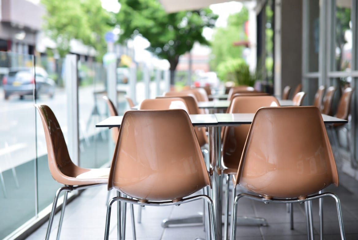 Clean shiny plastic chairs set up in a New Zealand café or outdoor setting