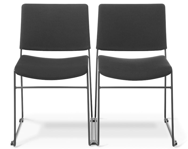 Close-up of linking feet connecting two commercial stacking chairs in a venue row