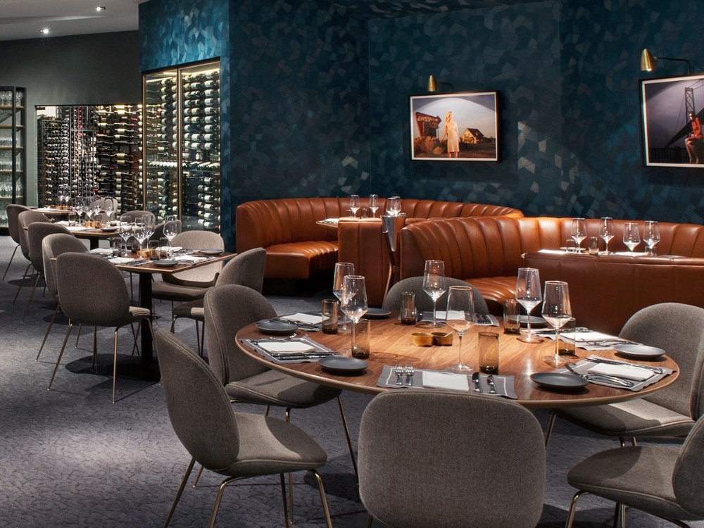 Best cafe chairs NZ 2025 - Stylish durable stackable seating in modern New Zealand cafe setting with natural timber and metal finishes