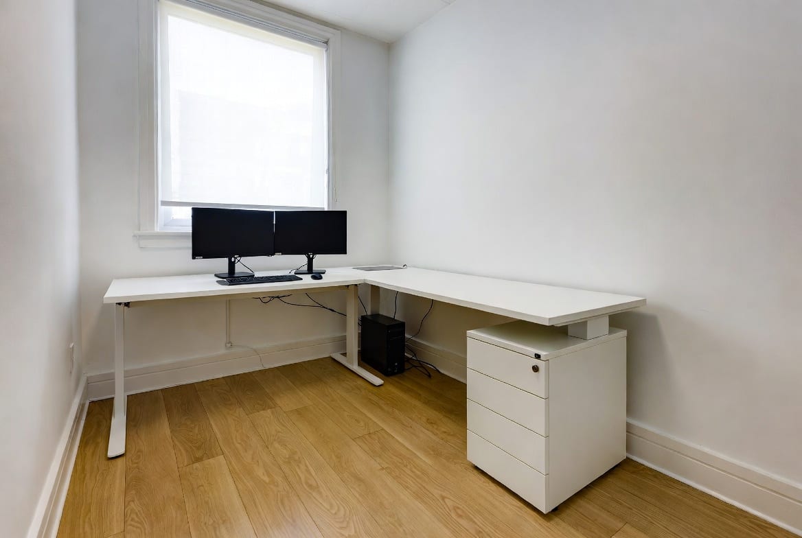 L-shaped office desk maximising space in a compact Christchurch office