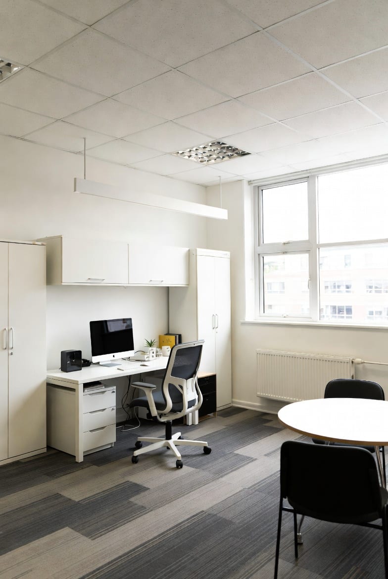 Modern startup office setup with desks, chairs and storage in bright NZ workspace