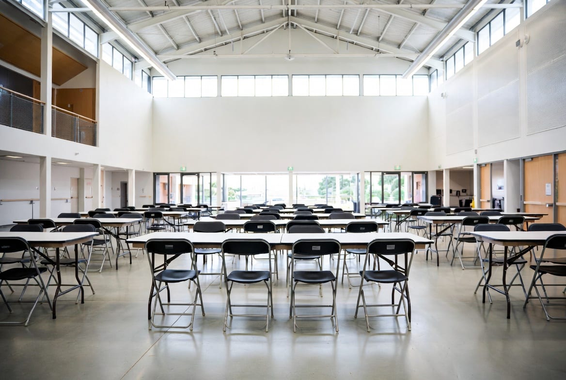 Trestle tables set up in an Auckland school hall or event venue