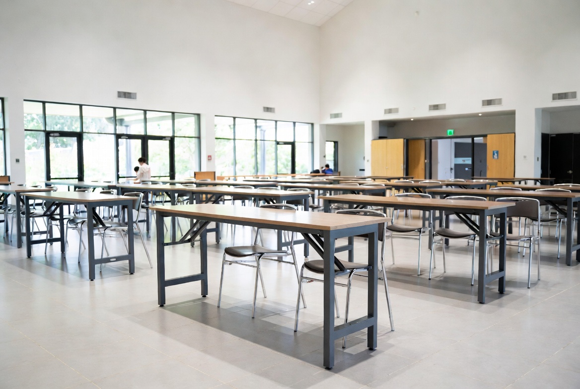Trestle tables set up in a Manukau City school hall or community venue