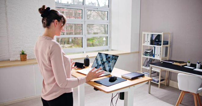person using a standing desk while working
